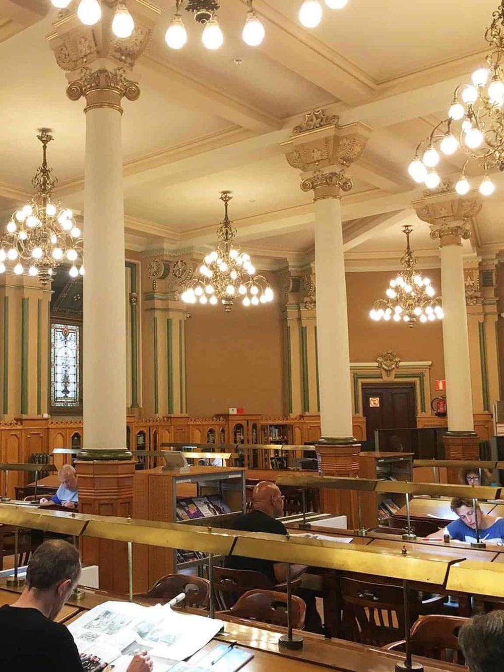 Elegant historic courthouse interior with classic columns and chandeliers, highlighting legal proceedings and architecture.
