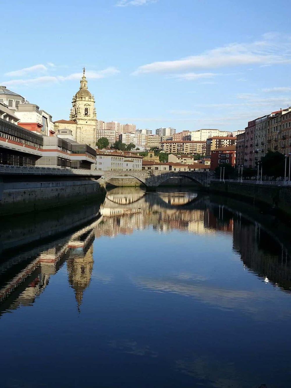 Historic cityscape of San Francisco with iconic architecture along a reflective waterway, emphasizing urban navigation and sightseeing.