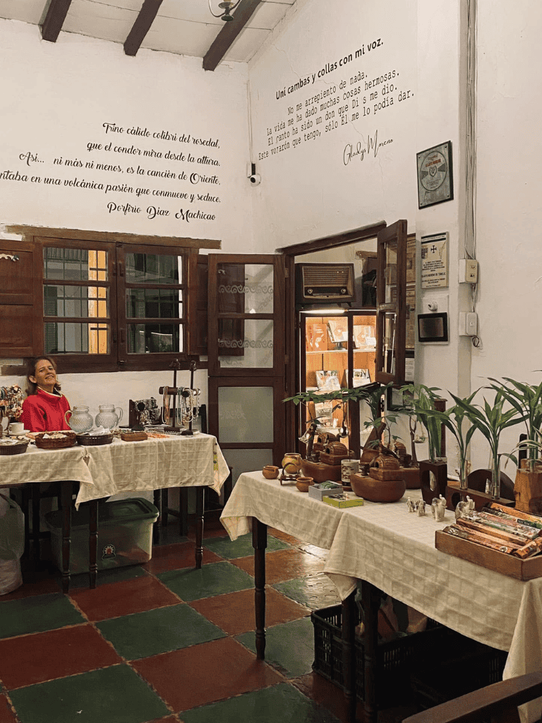 Colorful market stall with ceramic and wooden crafts in a cozy shop setting.