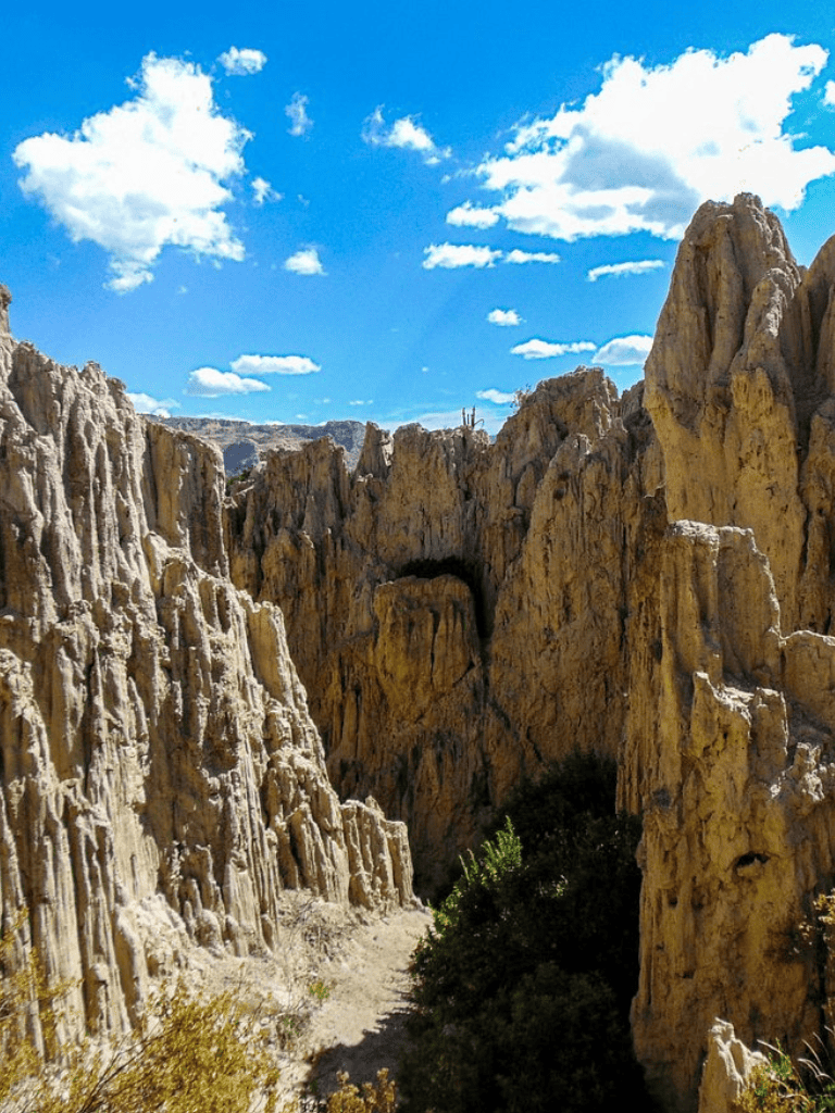 Breathtaking rocky canyon with bright blue sky and clouds, ideal for adventure and nature travel.