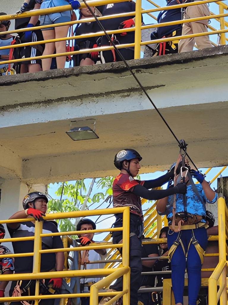 Climbing and safety training at QuestForDirections adventure park, with staff guiding participants on ropes course.