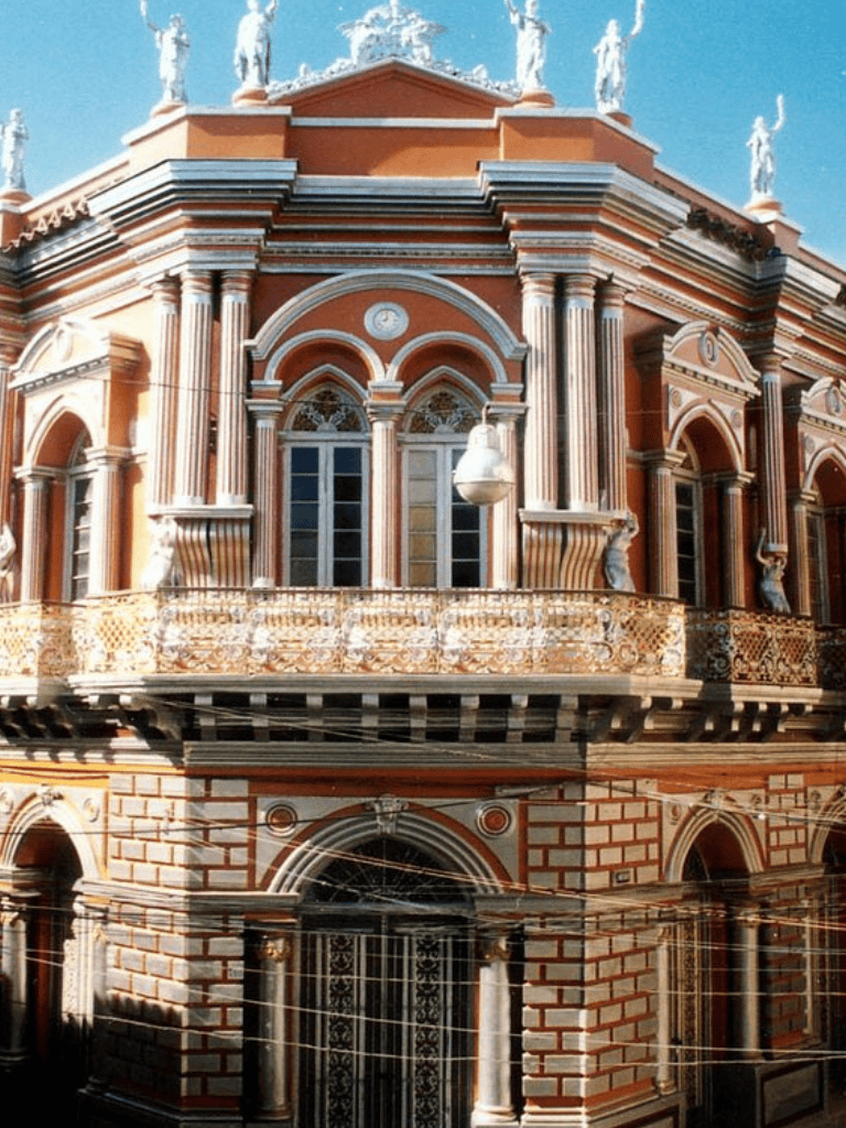 Elegant historic building with ornate architectural details and sculptures, showcasing classic European design.