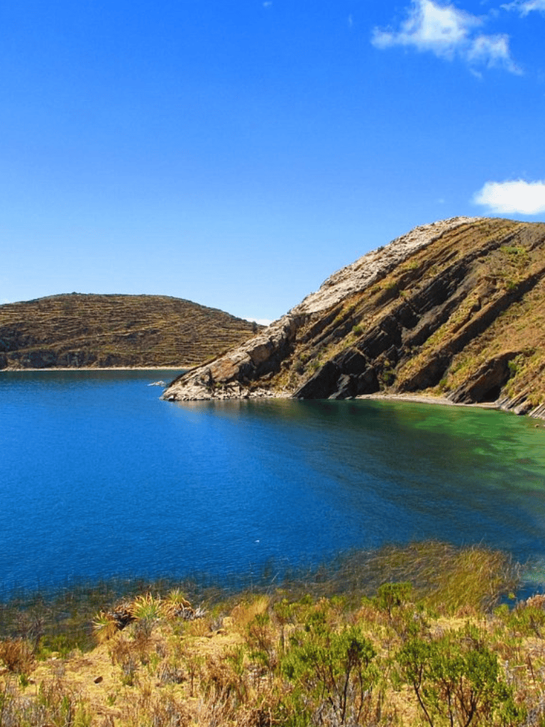 Scenic landscape with rocky hills and turquoise lake, perfect for outdoor adventures and nature exploration.