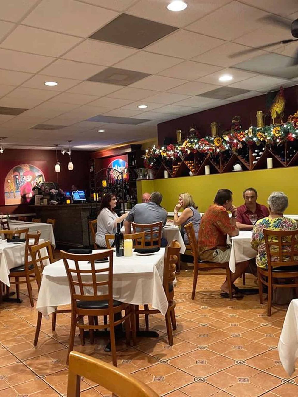 Cozy restaurant interior with decorated walls and diners enjoying their meals, vibrant ambiance, and excellent service.