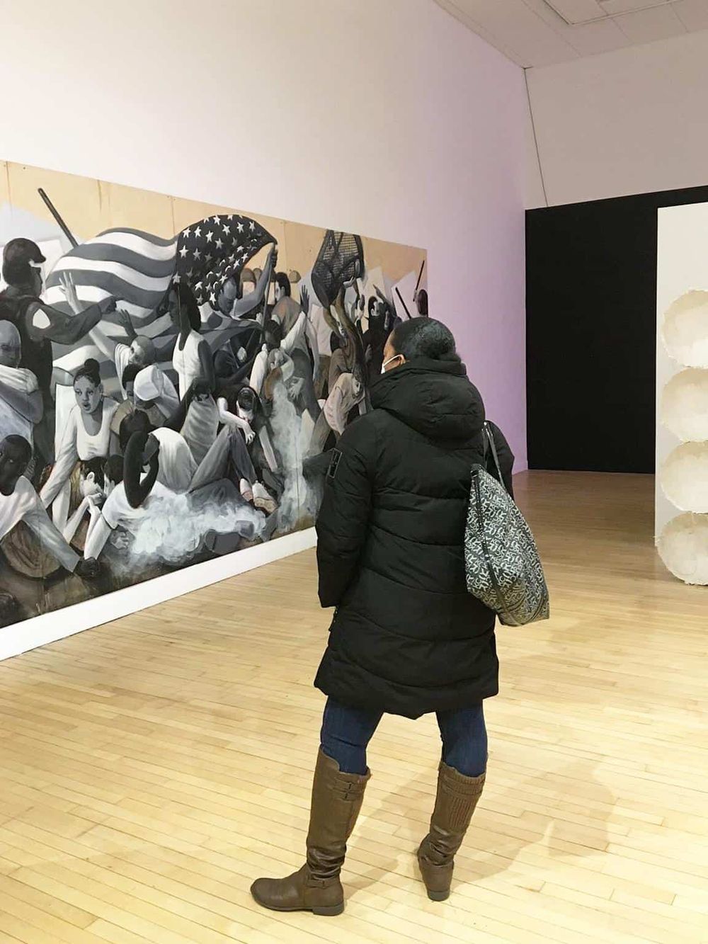 Vivid mural depicting a peaceful protest with diverse people and American flags at QuestForDirections exhibit.