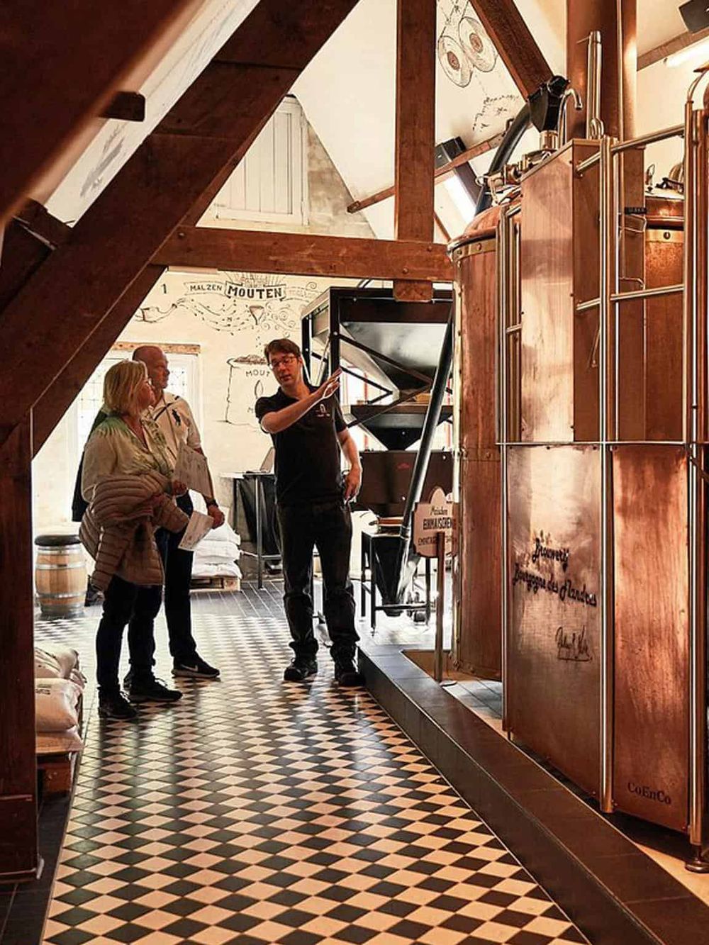 Vintage wine tasting room with wooden beams and a checkered floor, showcasing expert guidance and wine pourings.