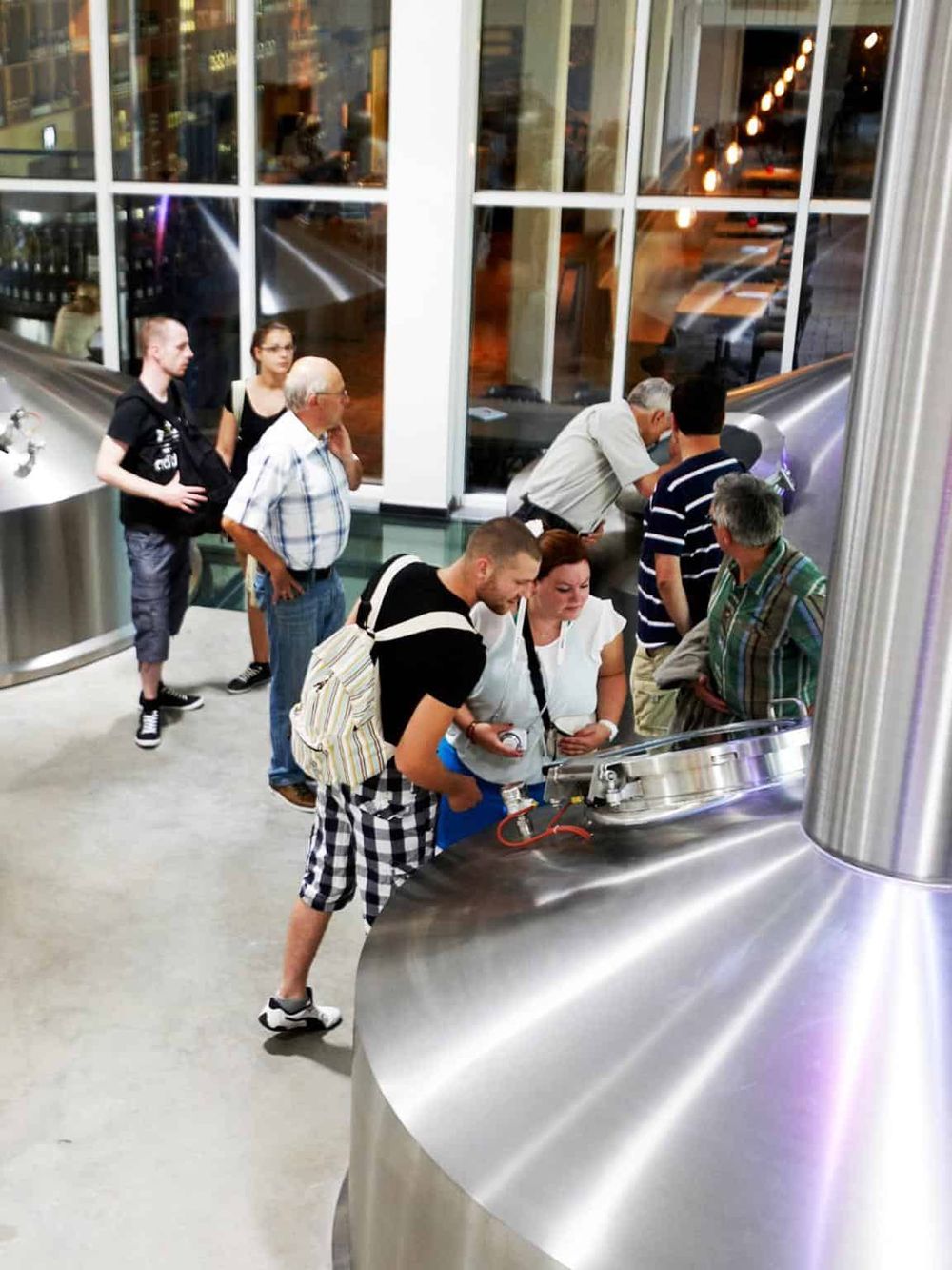 People at a modern brewery or tasting room.