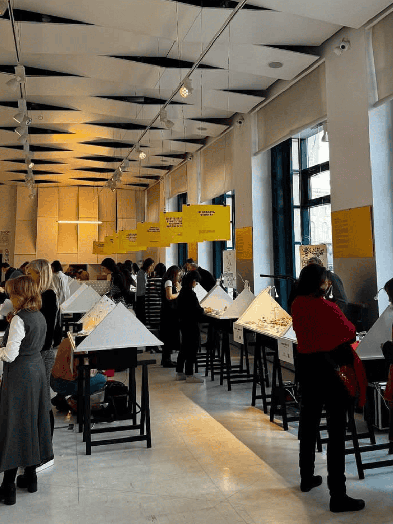 Baggage in theIU's Quest for Directions exhibition hall with visitors exploring jewelry displays.