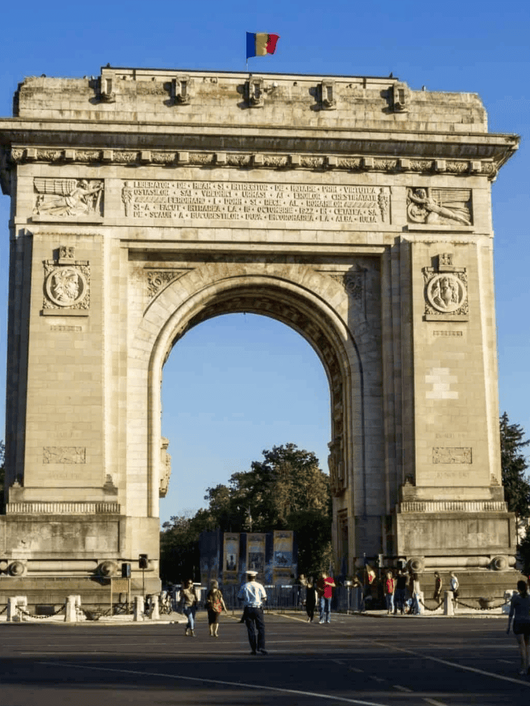 Victory Arch in Paris with tourists and the French flag.