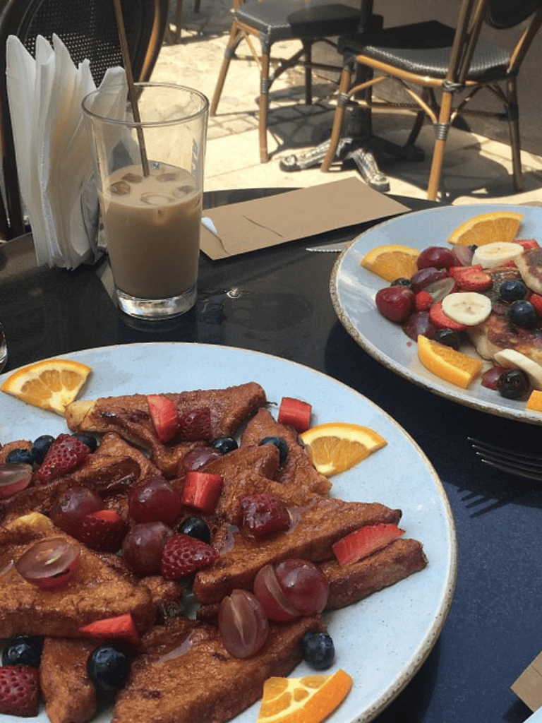 Sweet French toast with fresh berries, oranges, and a refreshing iced coffee at QuestForDirections café.