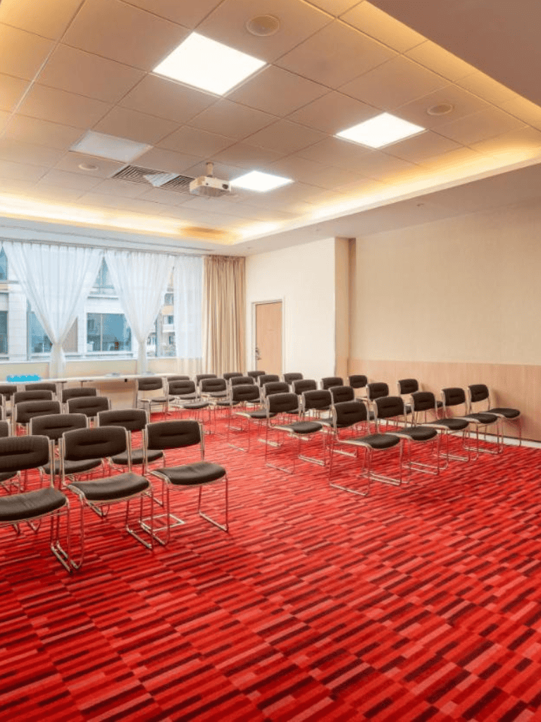 Comfortable conference room with ample seating and modern lighting, ideal for corporate events and meetings.