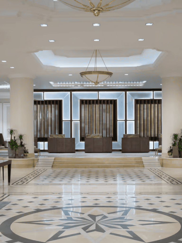 Elegant hotel lobby with modern lighting and decorative flooring for luxury hospitality experiences.