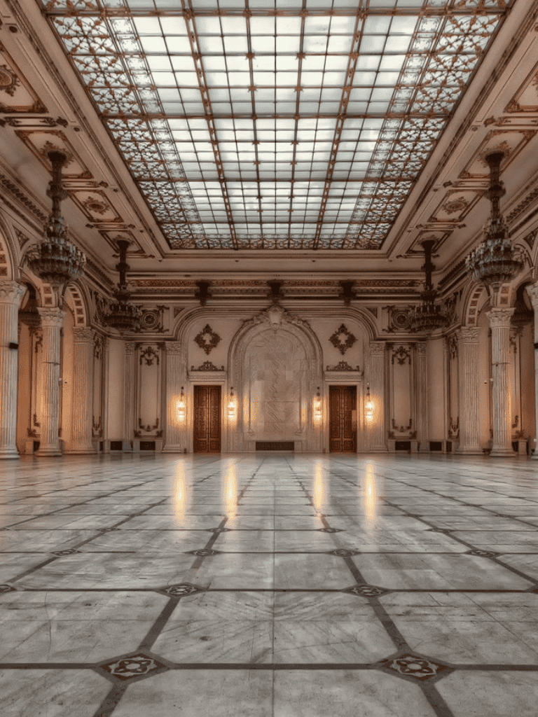 Elegant historic palace interior with marble floors and ornate architectural details.