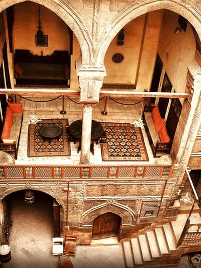 Rustic Moroccan courtyard with vibrant textiles and historic architecture, perfect for cozy gatherings.