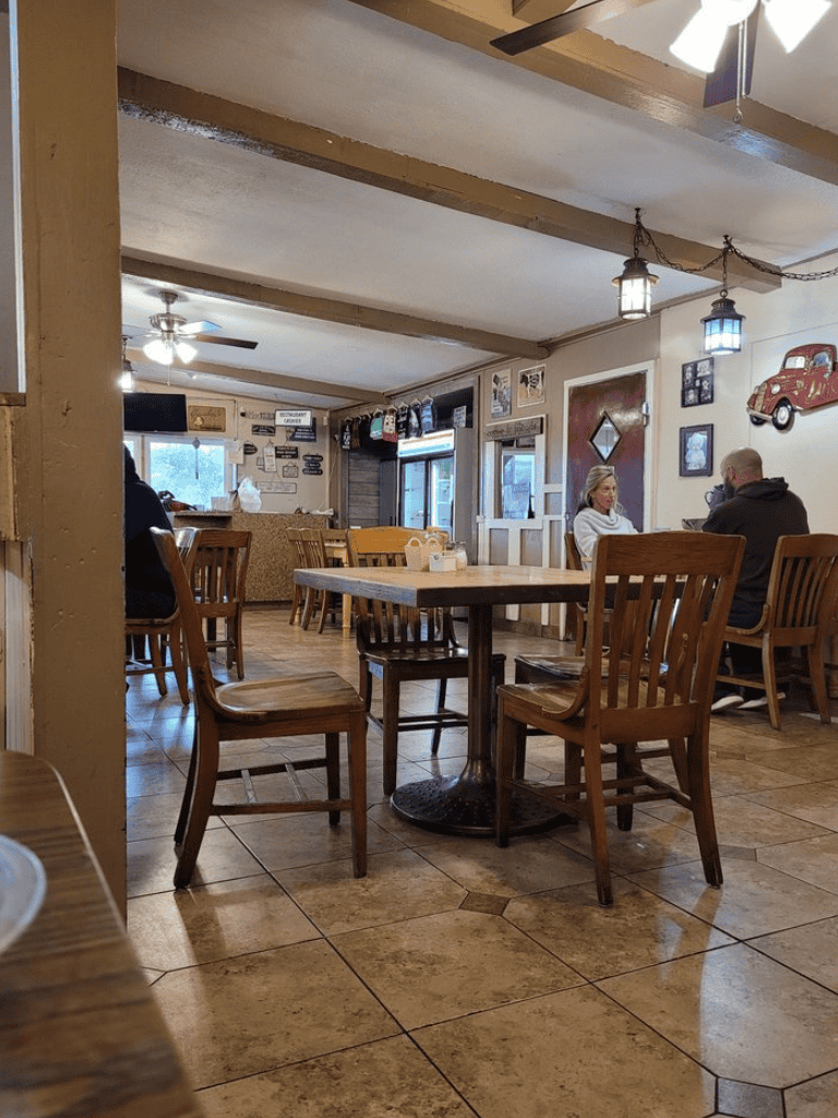 Cozy restaurant interior with wooden furniture, vintage decor, and casual dining atmosphere.