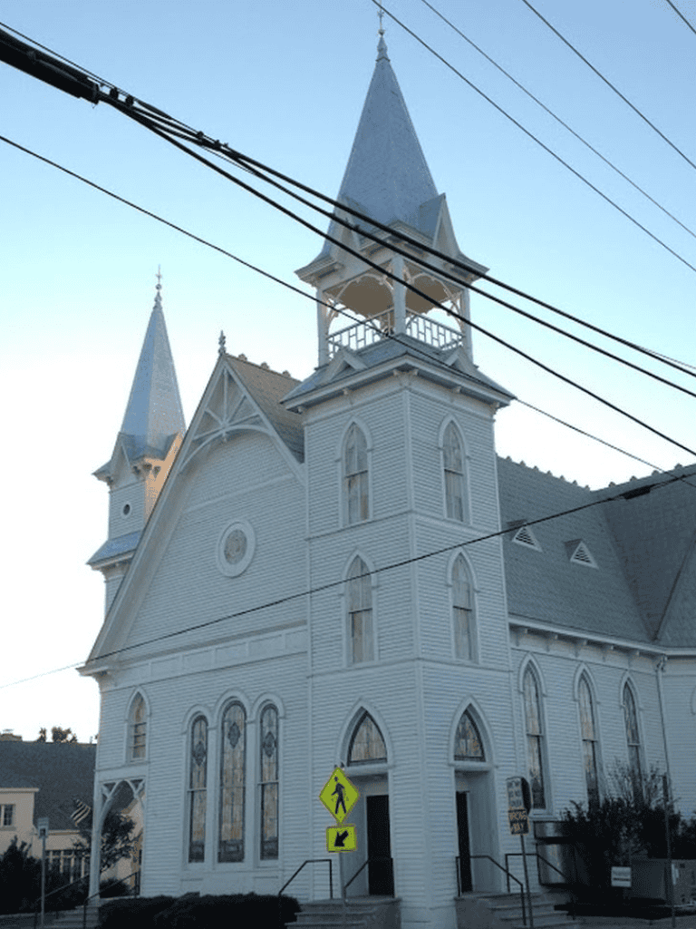 Elegant historic church with Gothic windows and steeples, iconic landmark in QuestForDirections location.