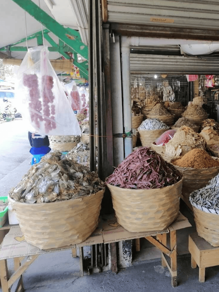 Dried spices and herbs in baskets at a local market in QuestForDirections location.