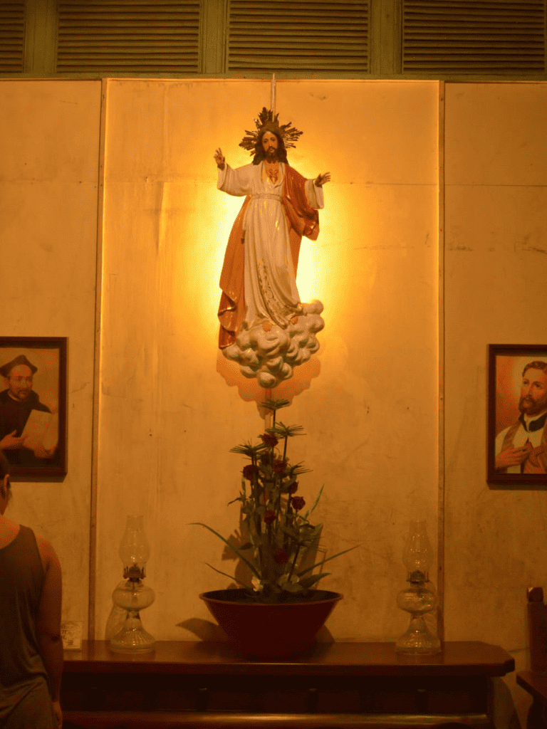 Divine Jesus statue in prayer, religious artwork, and devotional display, spiritual ambiance, Christian faith focus.