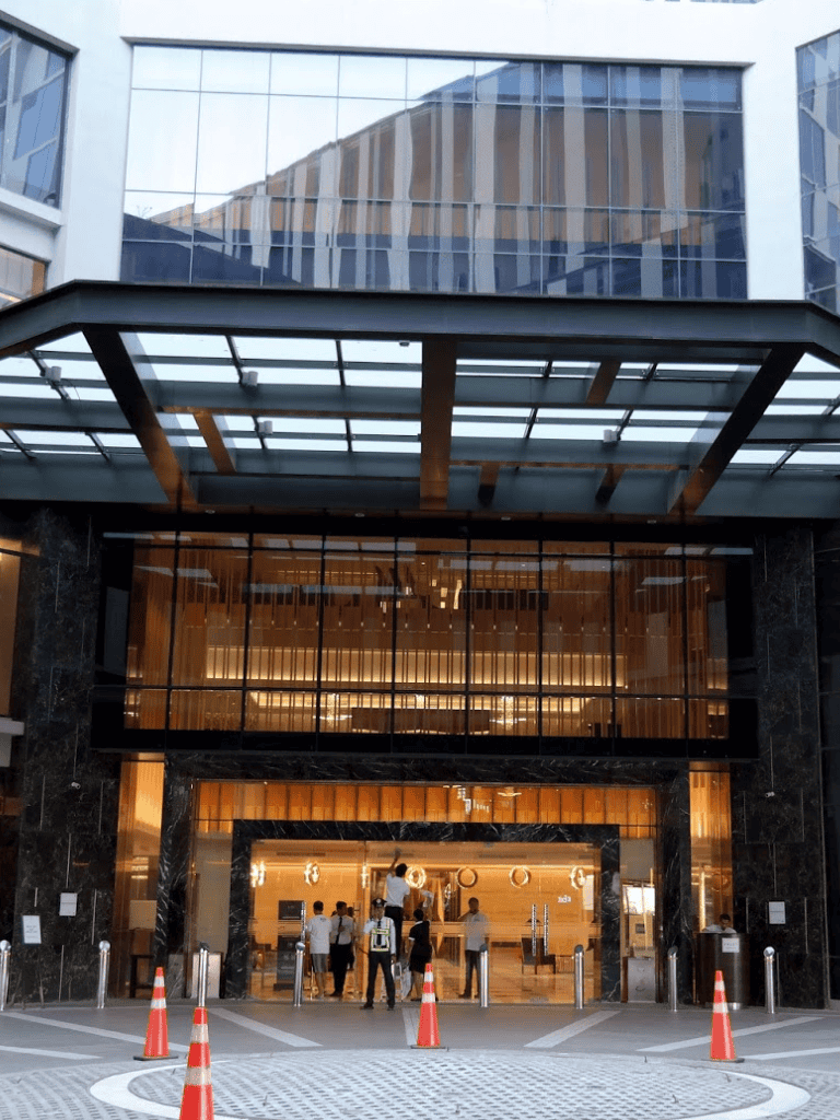 Modern office building with glass facade and active entry area, business district facade.