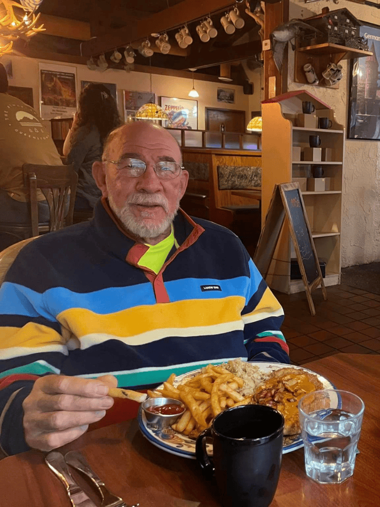 Delicious plate of comfort food with fries, breaded chicken, and gravy in cozy restaurant setting.