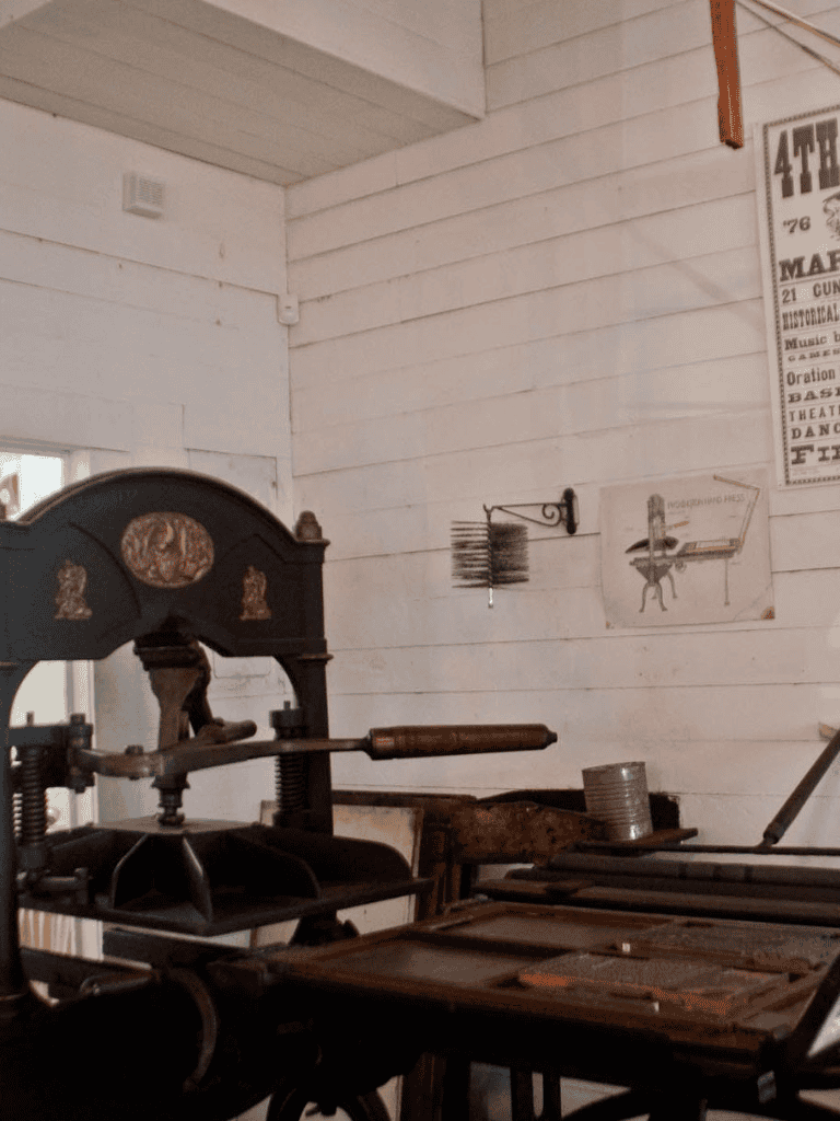 Antique printing press in vintage workshop for historical printing and letterpress art.