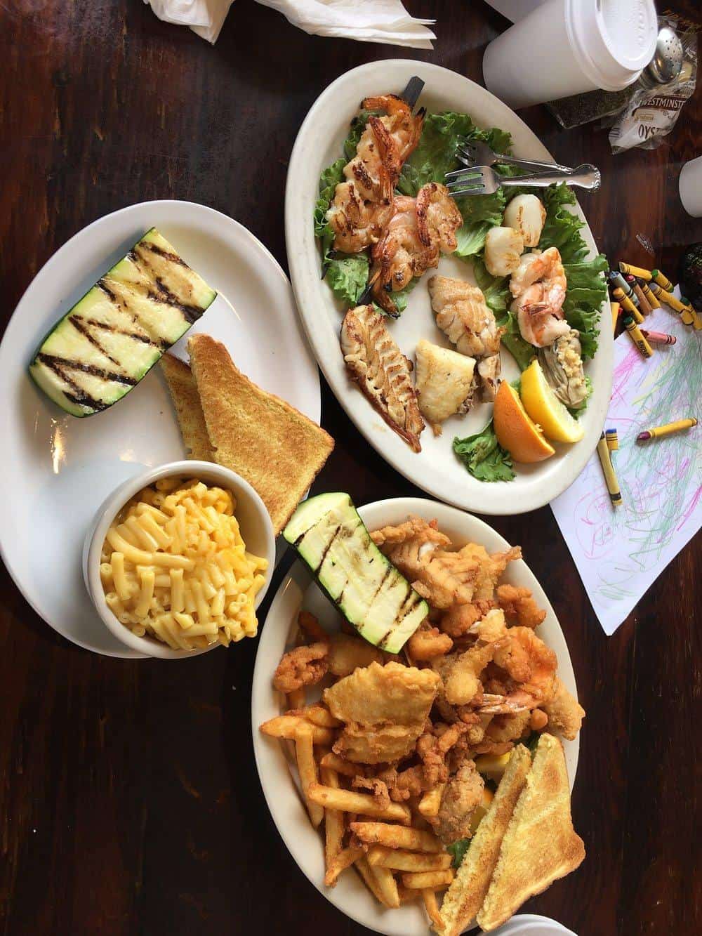 Fresh seafood platter with lemon wedges and greens for a delicious meal.