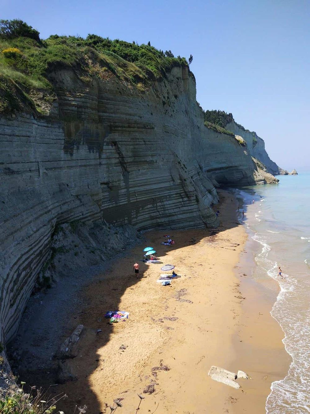 Stunning coastal cliffs with sandy beach, popular for guided tours and seaside adventures.