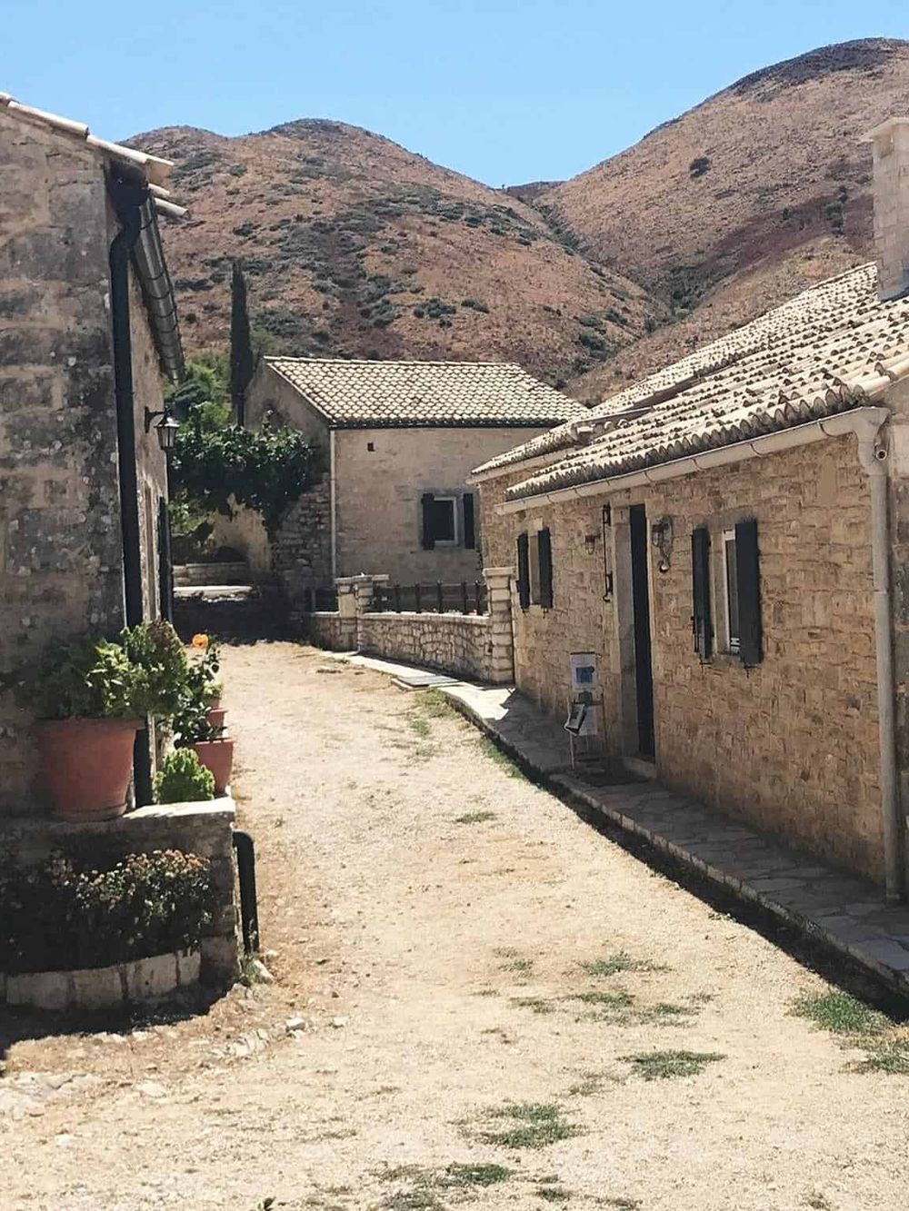 Quaint stone houses with tiled roofs in a mountain village, scenic travel destination, rustic architecture for vacation travel.