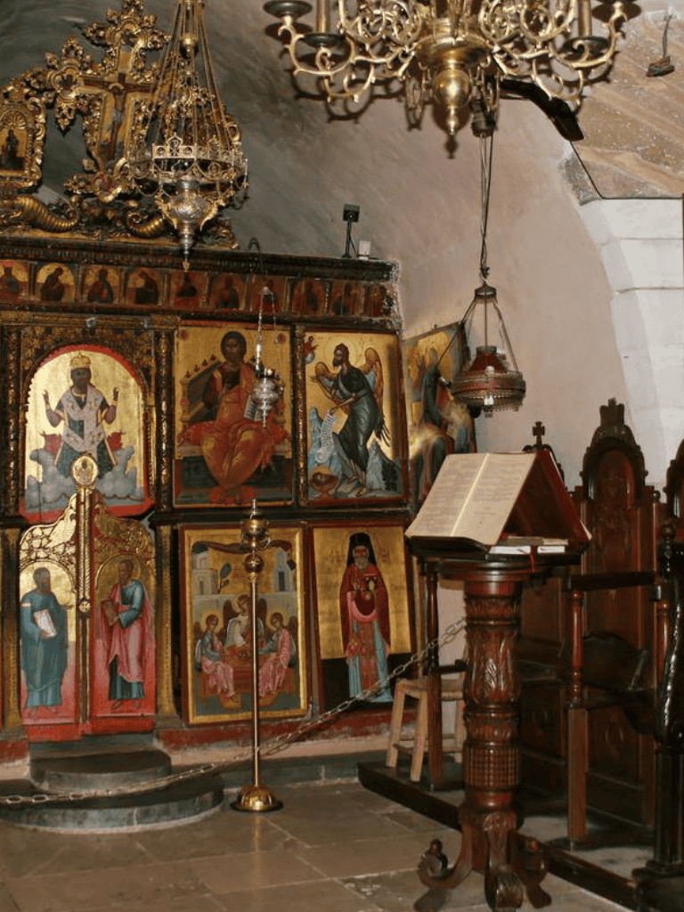 Intricate religious icons display inside a historic church, showcasing traditional Christian art and sacred decor.