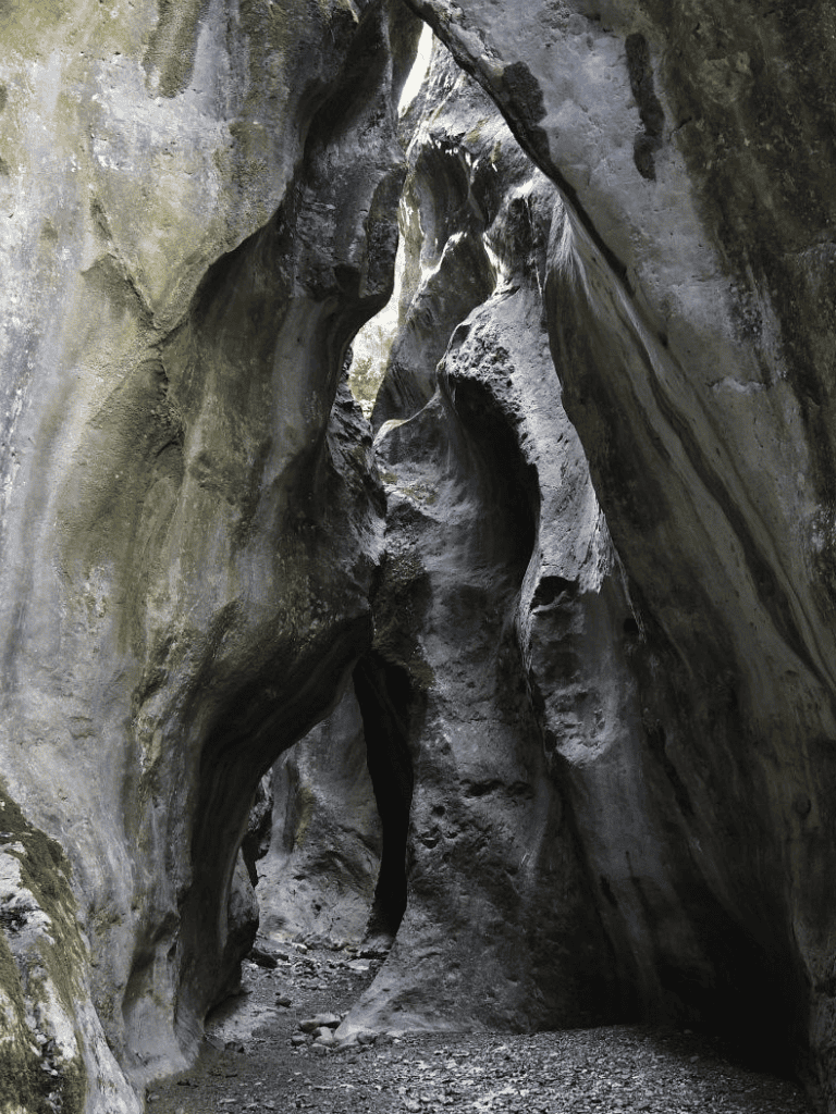 Intricate canyon passage with smooth, weathered rock formations, ideal for adventure and exploration.