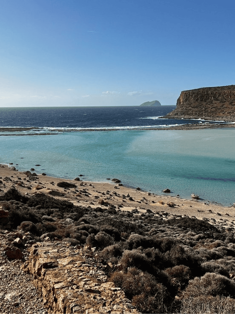 Beach with turquoise waters and rocky cliffs, perfect for scenic coastal exploration.