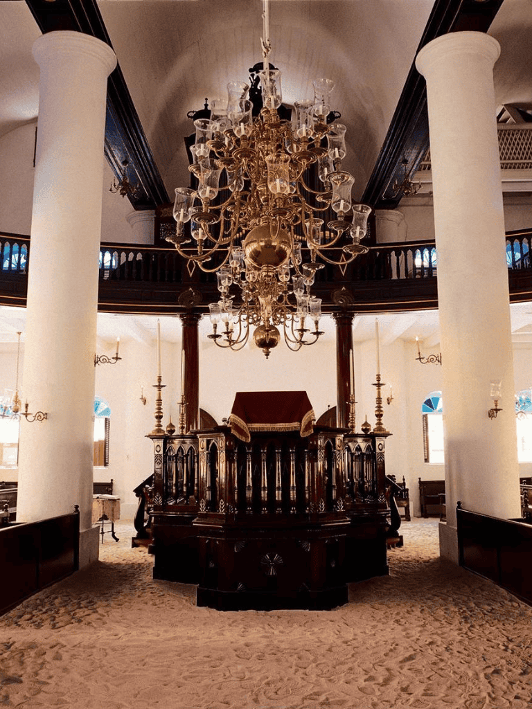 Elegant church interior with grand chandelier and wooden pulpit, ideal for wedding ceremonies and religious events.