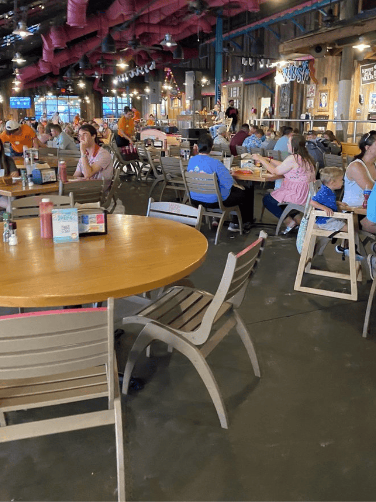 Indoor casual dining restaurant with families and friends, rustic decor, and lively atmosphere.