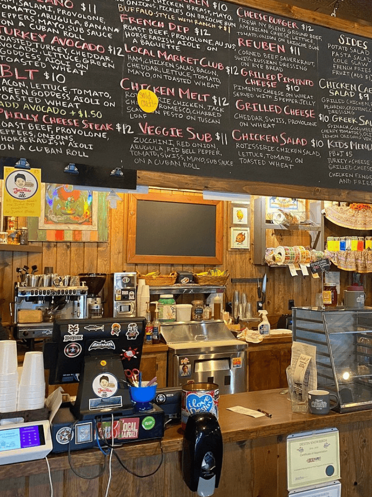 Coffee shop interior with menu board and wooden decor, casual cafe ambiance, cozy and inviting atmosphere for customers.