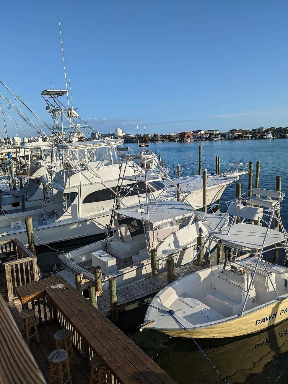 Marina with luxury boats docked, sunny clear sky, waterfront scene, boating destination, yacht marina, seascape, QuestForDirections.