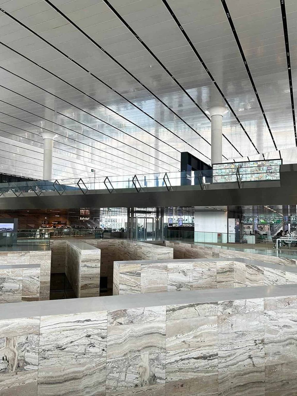 Bright modern airport interior with glass walls and marble accents, ideal for travel and navigation.
