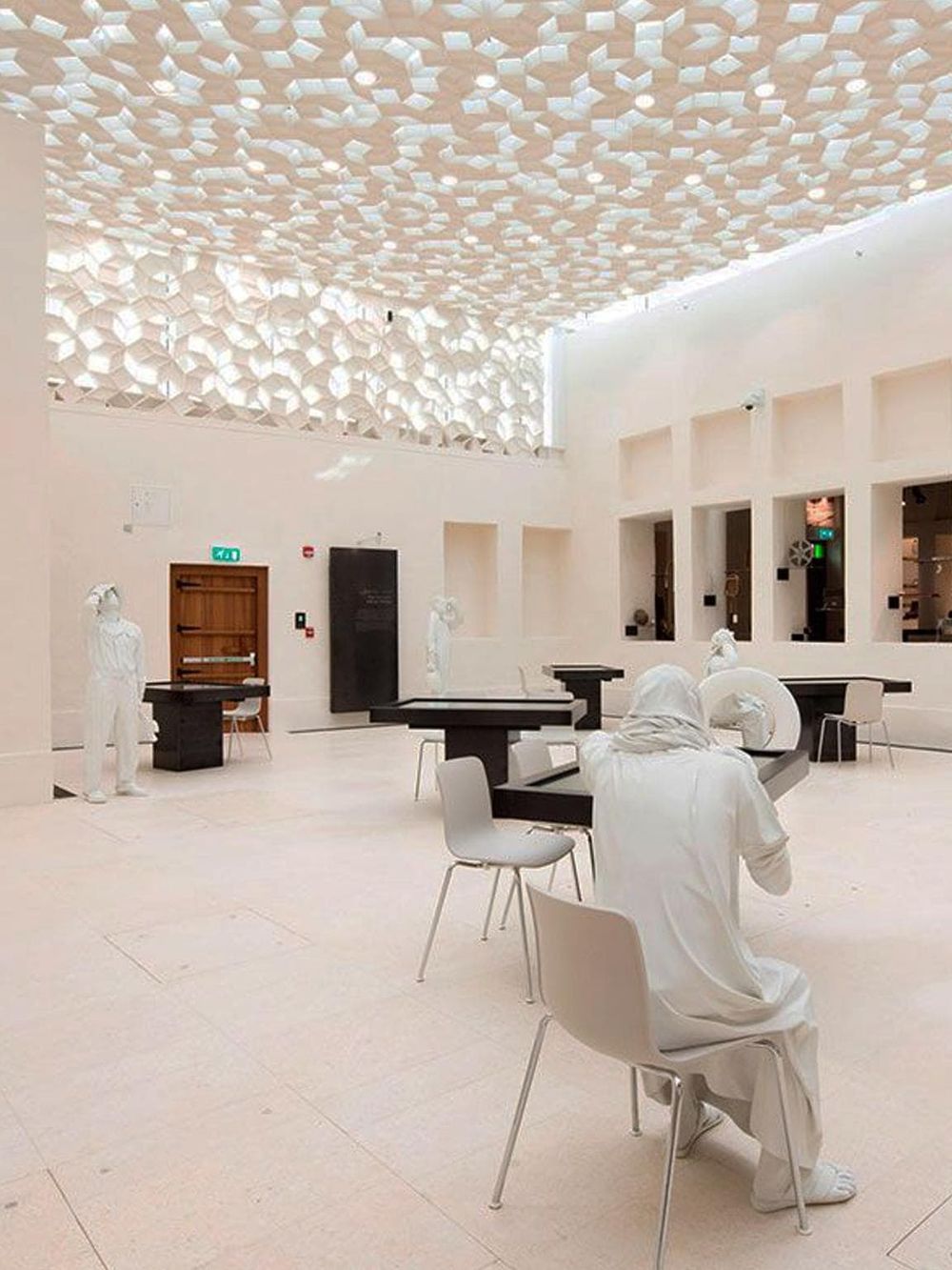 Contemporary interior design of QuestForDirections, featuring modern art sculptures and innovative ceiling architecture.