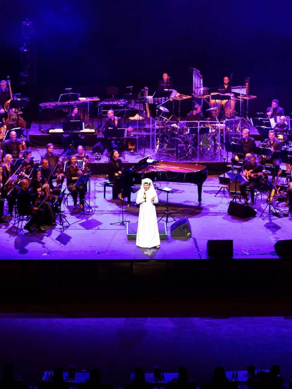 Elegant orchestra performance at QuestForDirections event with live music and stage lighting.