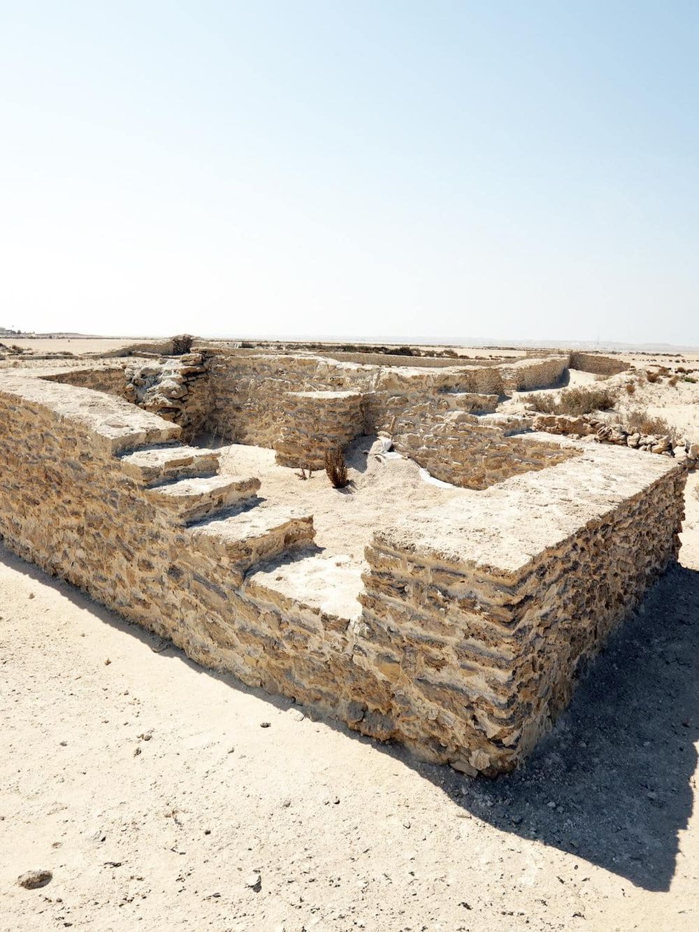 Ancient archaeological site in desert, stone ruins, historical excavation, desert landscape, QuestForDirections.