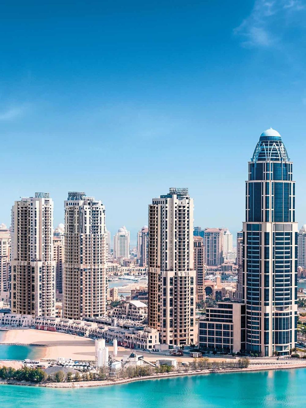 Modern city skyline featuring high-rise buildings and a waterfront view in Dubai.