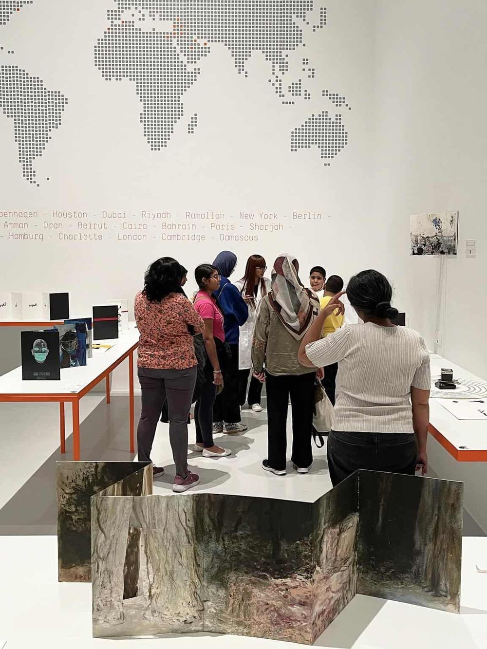 Modern art exhibition with diverse visitors exploring creative displays.