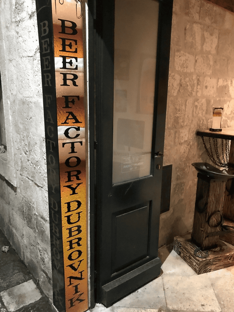 Vintage brewery history sign near door at QuestForDirections.