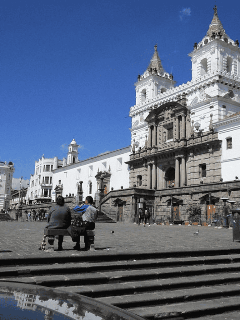 Historic church in a bustling city square, popular destination for tourists and locals alike.