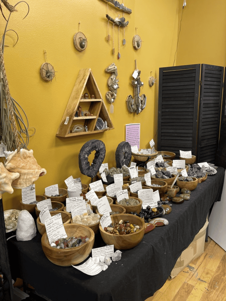 Polished gemstones and minerals displayed at QuestForDirections store, showcasing natural crystal treasures.