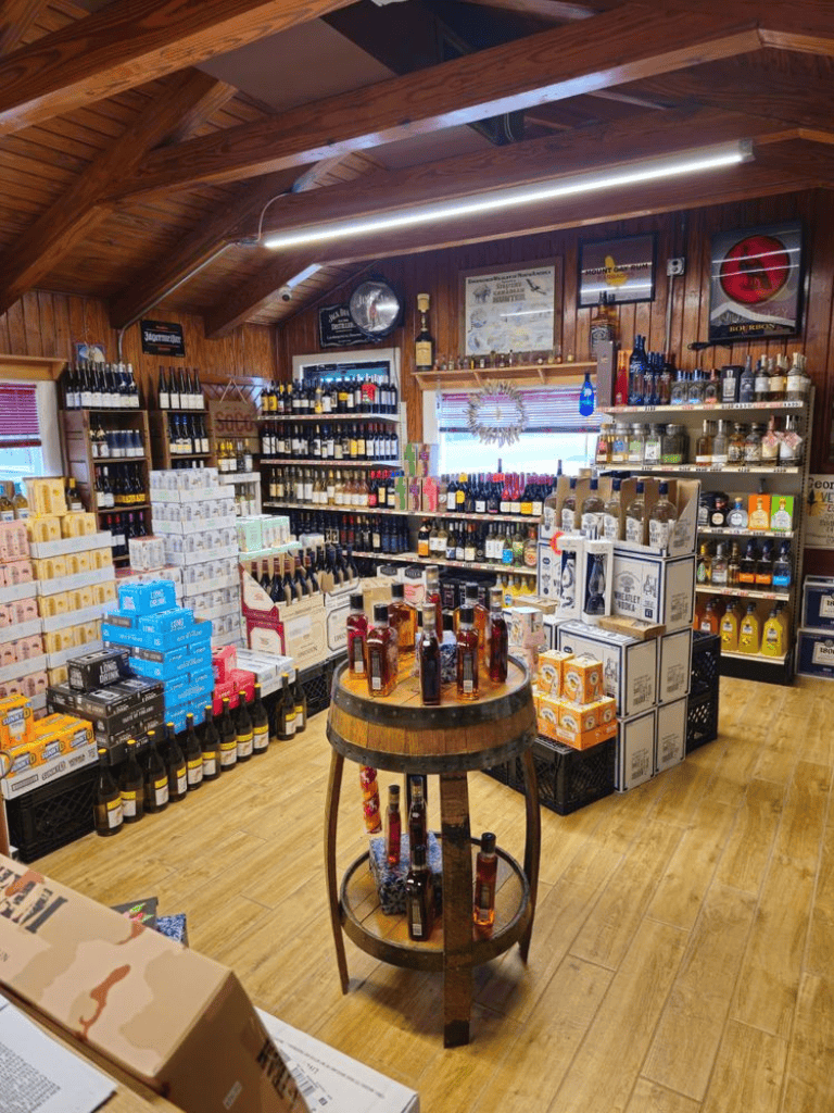 Premium liquor store with a wide selection of spirits and wine, featuring a cozy, wood-paneled interior and inviting display displays.