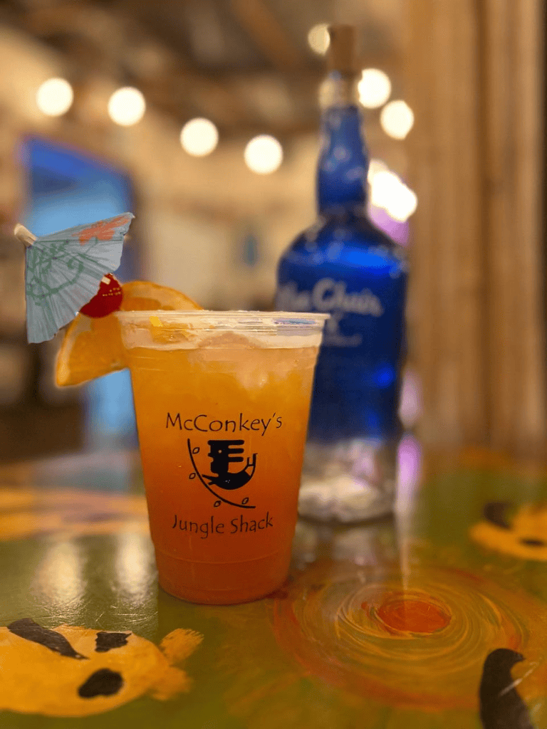 Refreshing tropical cocktail with orange and a decorative umbrella at Jungle Shack bar.