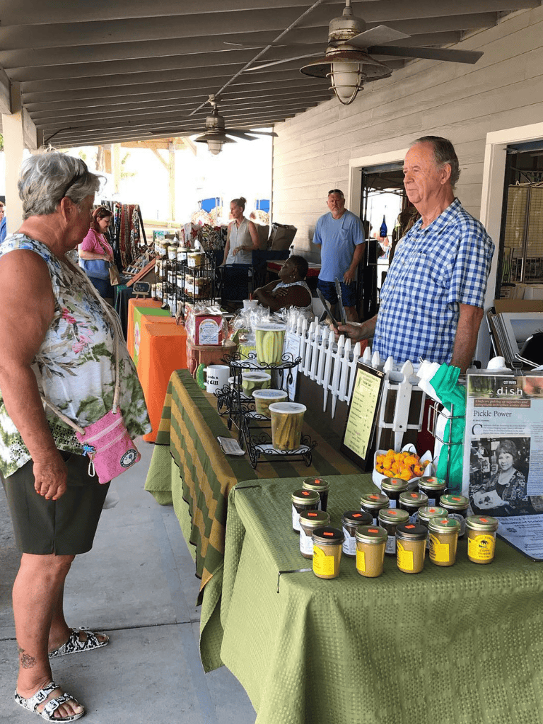 Fresh produce and handmade goods at a local outdoor market stall.
