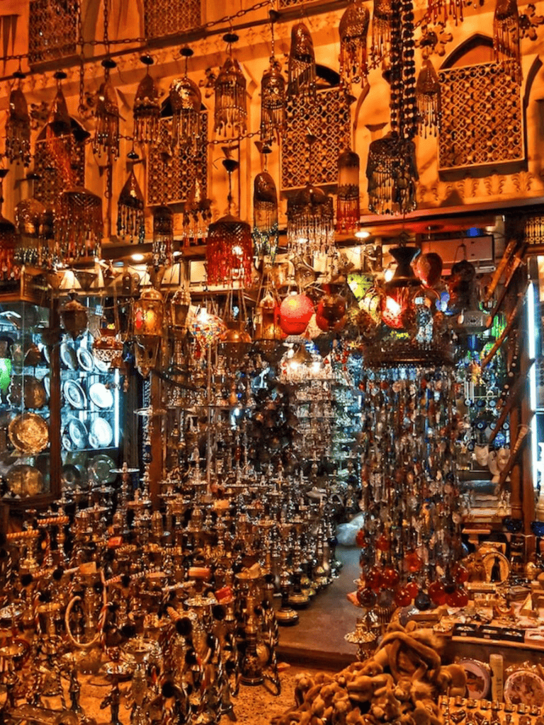 Colorful Moroccan lanterns and decorative trinkets in a bustling marketplace stall.