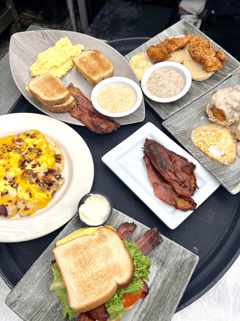 Scrambled eggs, bacon, toast, fried chicken, breakfast platter with gravy, cheeseburger sandwich, and pizza.