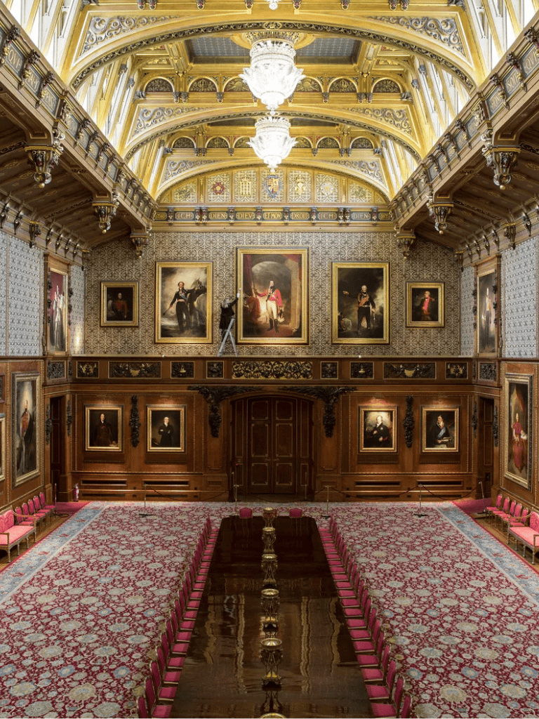 Elegant historic interior with ornate woodwork and grand paintings, perfect for cultural tours and museum visits.